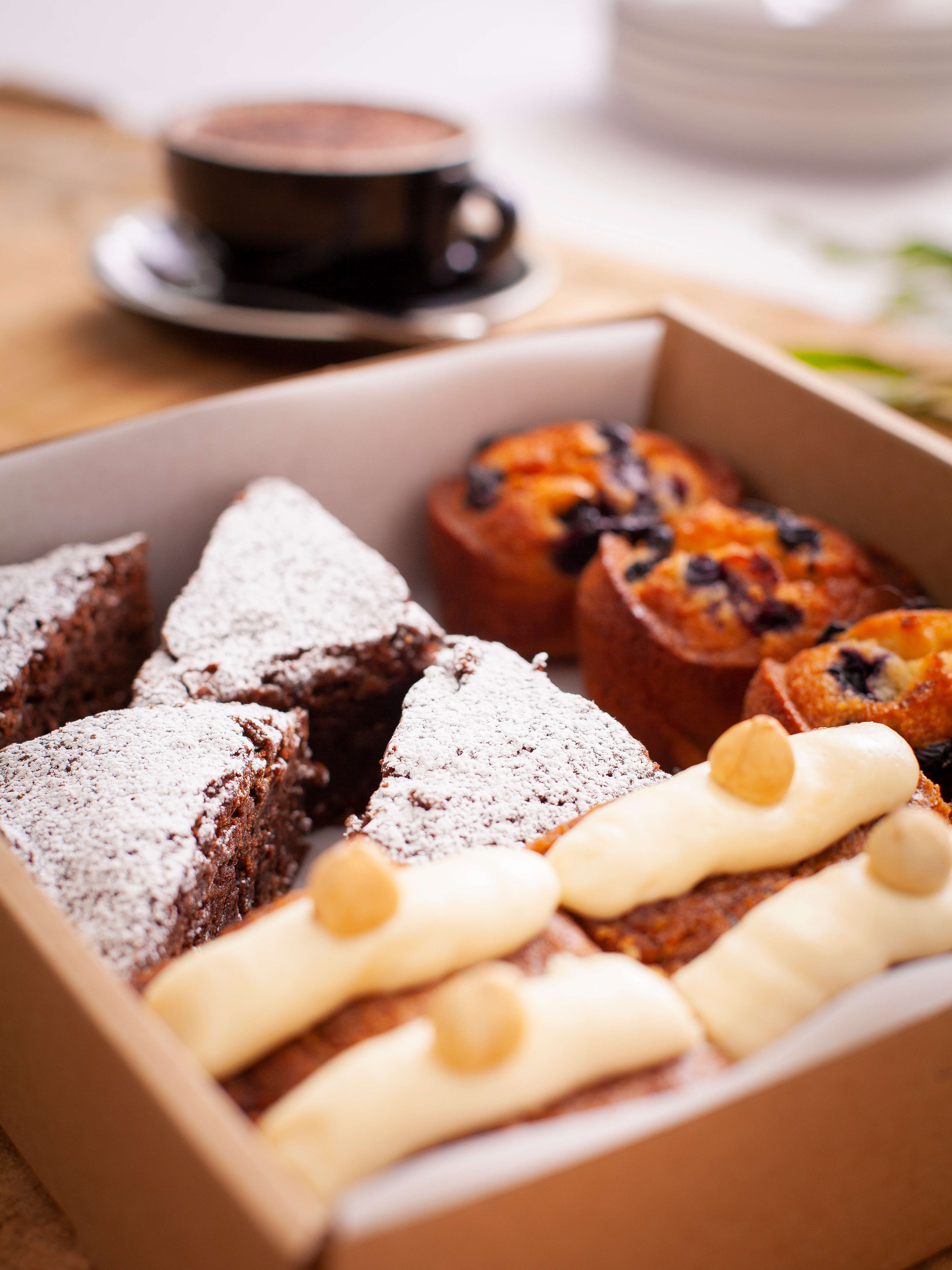 Cappuccino with gluten free sweet box containing 12 items including chocolate brownie, friands, cake. Photo: Richard Jupe.