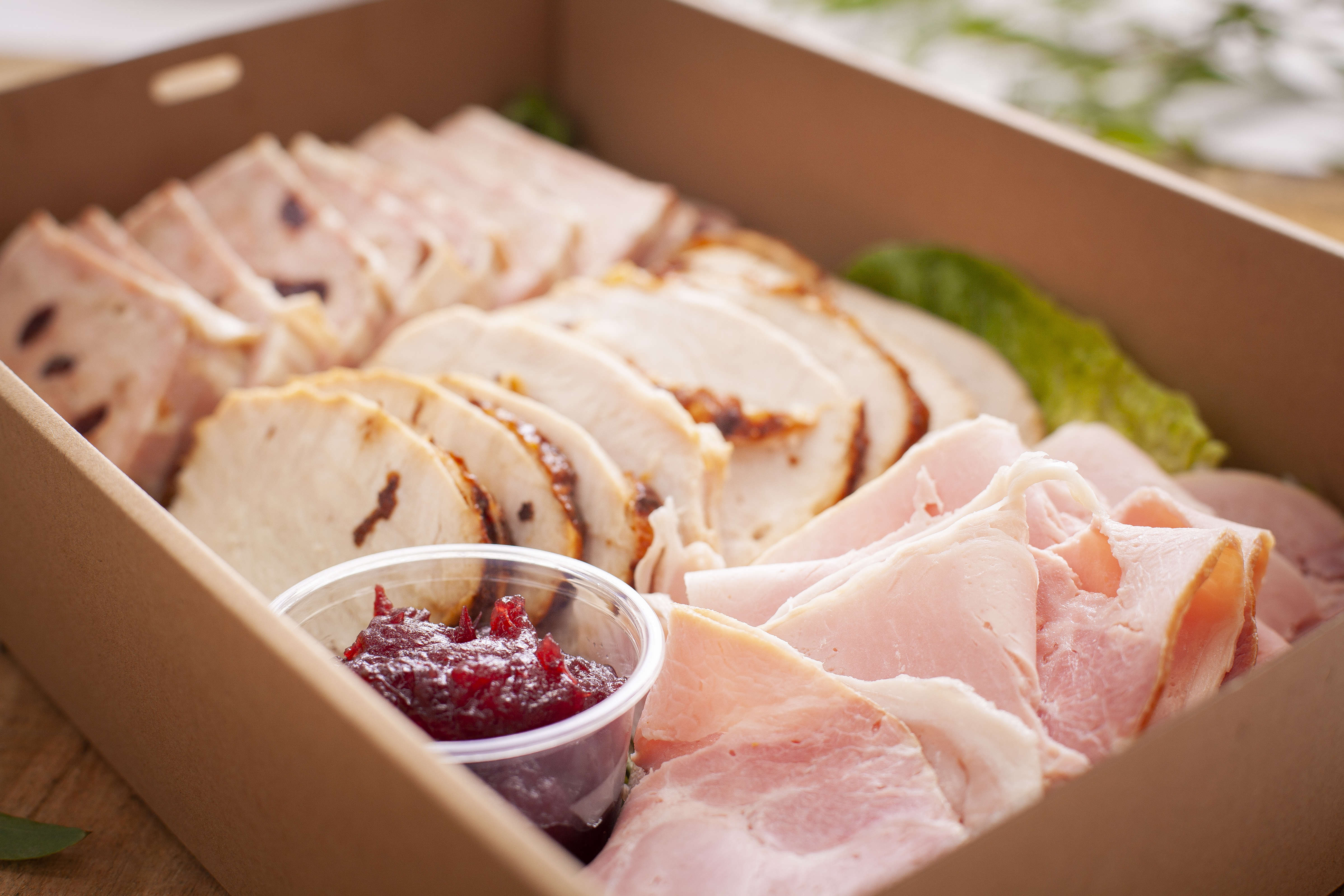 Cold meats catering box featuring quince glazed roast, turkey, Scottsdale ham, chicken and cranberry terrine, and cranberry sauce. Photo: Richard Jupe.