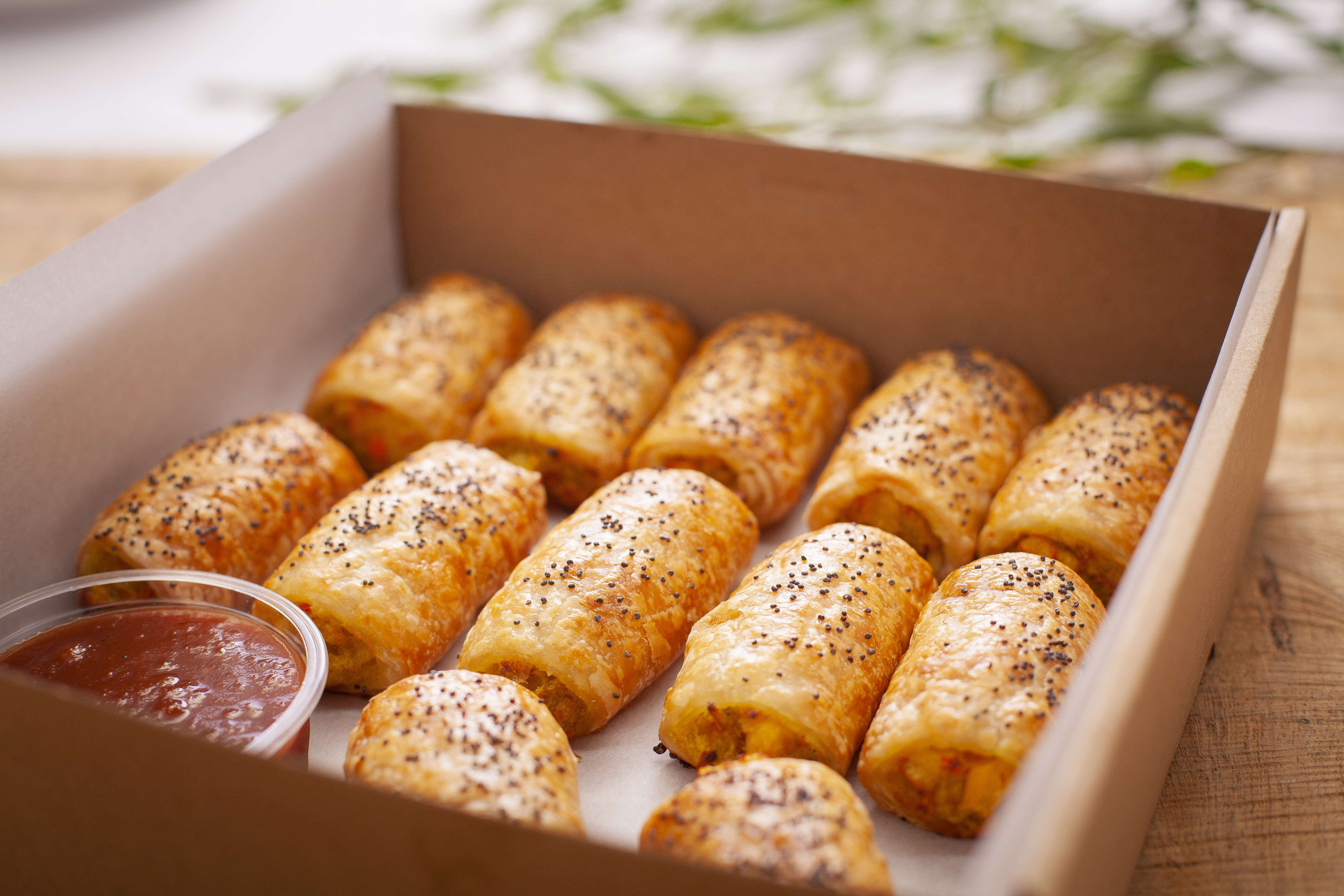 Savoury roll box containing 12 vegan savoury rolls with tomato relish. Photo: Richard Jupe.