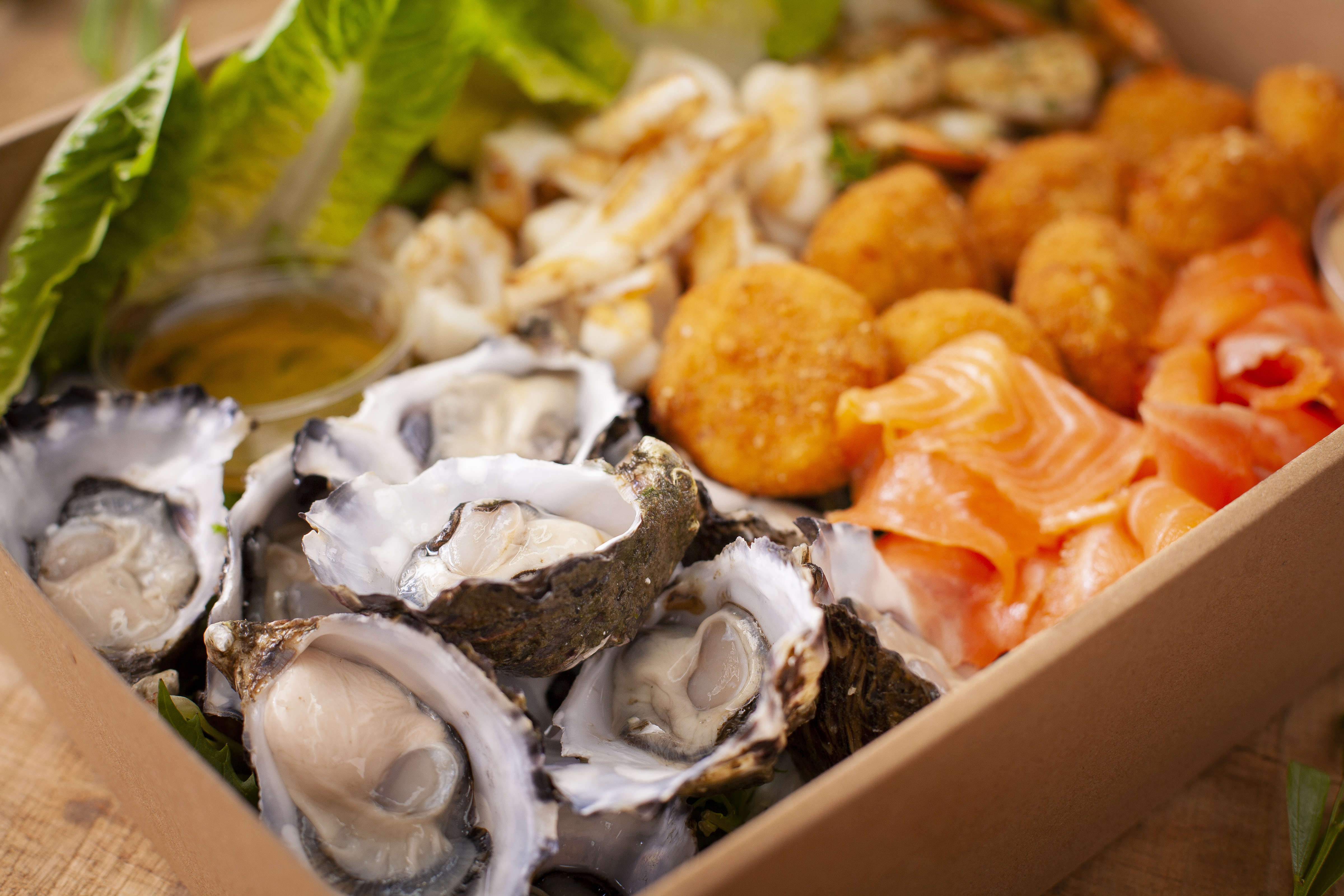 Close up of Christmas Seafood Box - includes fresh oysters, prawns, smoked salmon, fish cakes. Photo: Richard Jupe.