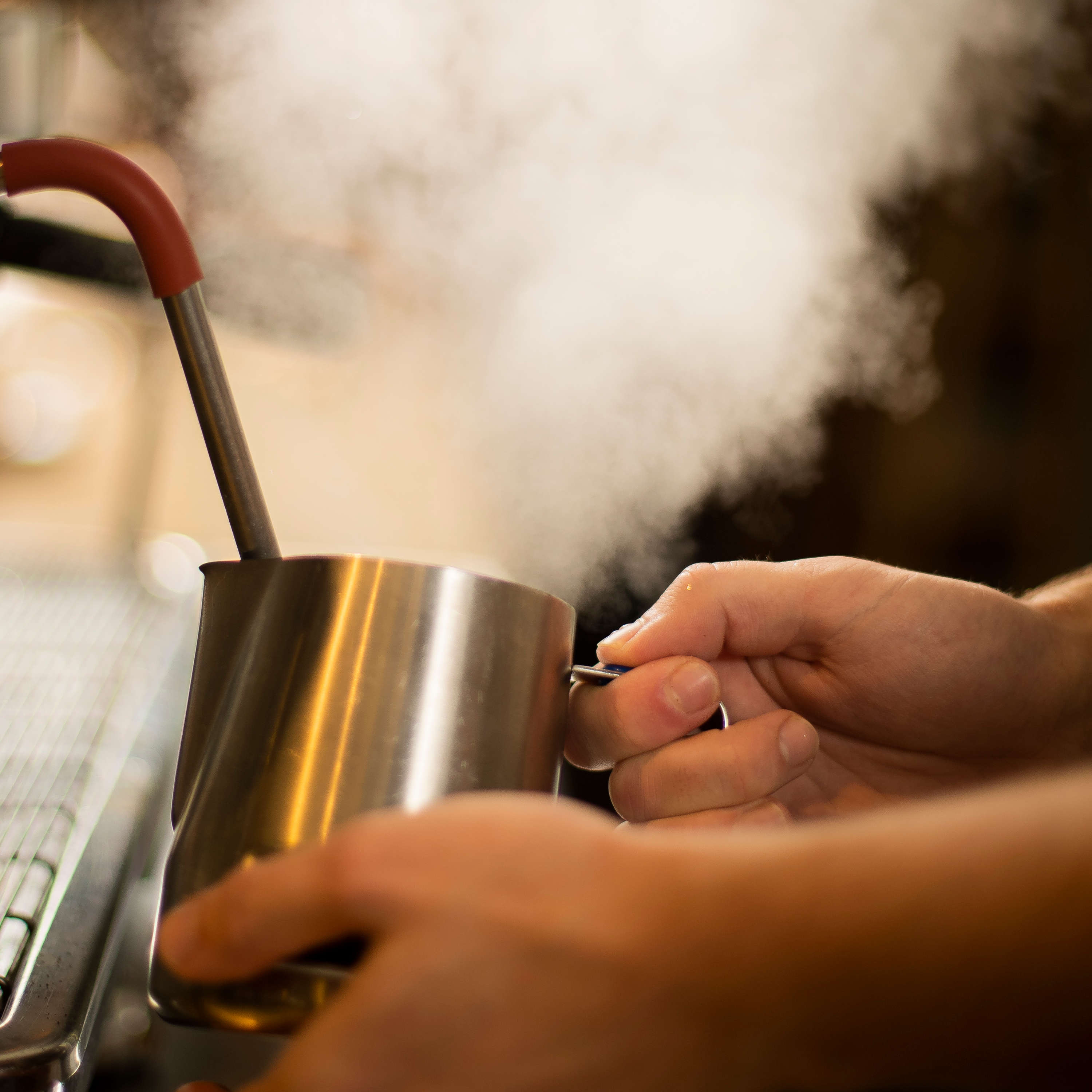 Close up of milk in a jug being steamed. Photo: Richard Jupe.