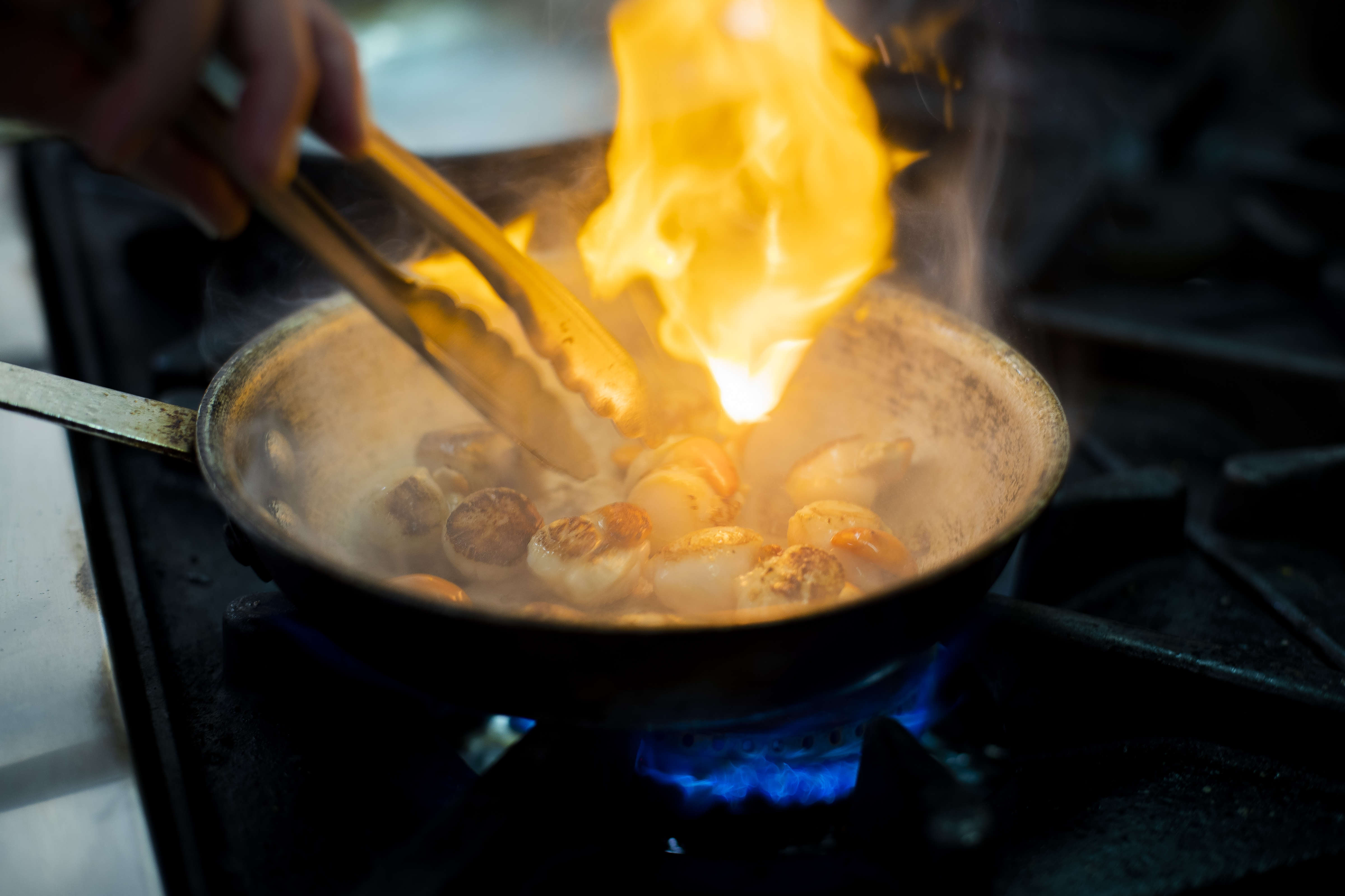Close up of chef frying scallops . Photo: Richard Jupe.