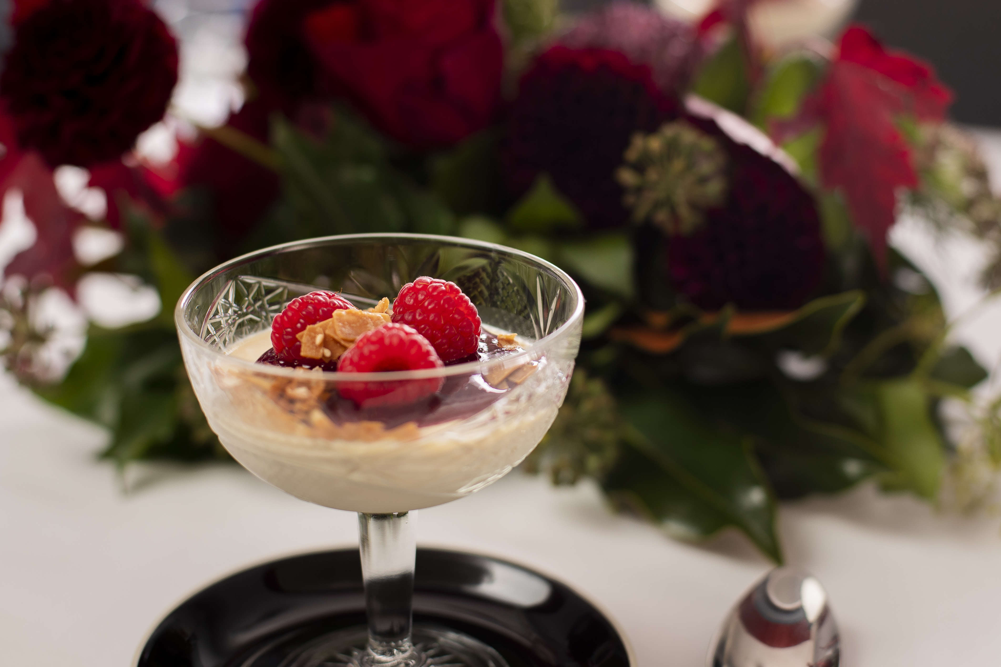 Vanilla panna cotta with raspberry coulis and fresh raspberries. Photo: Richard Jupe.