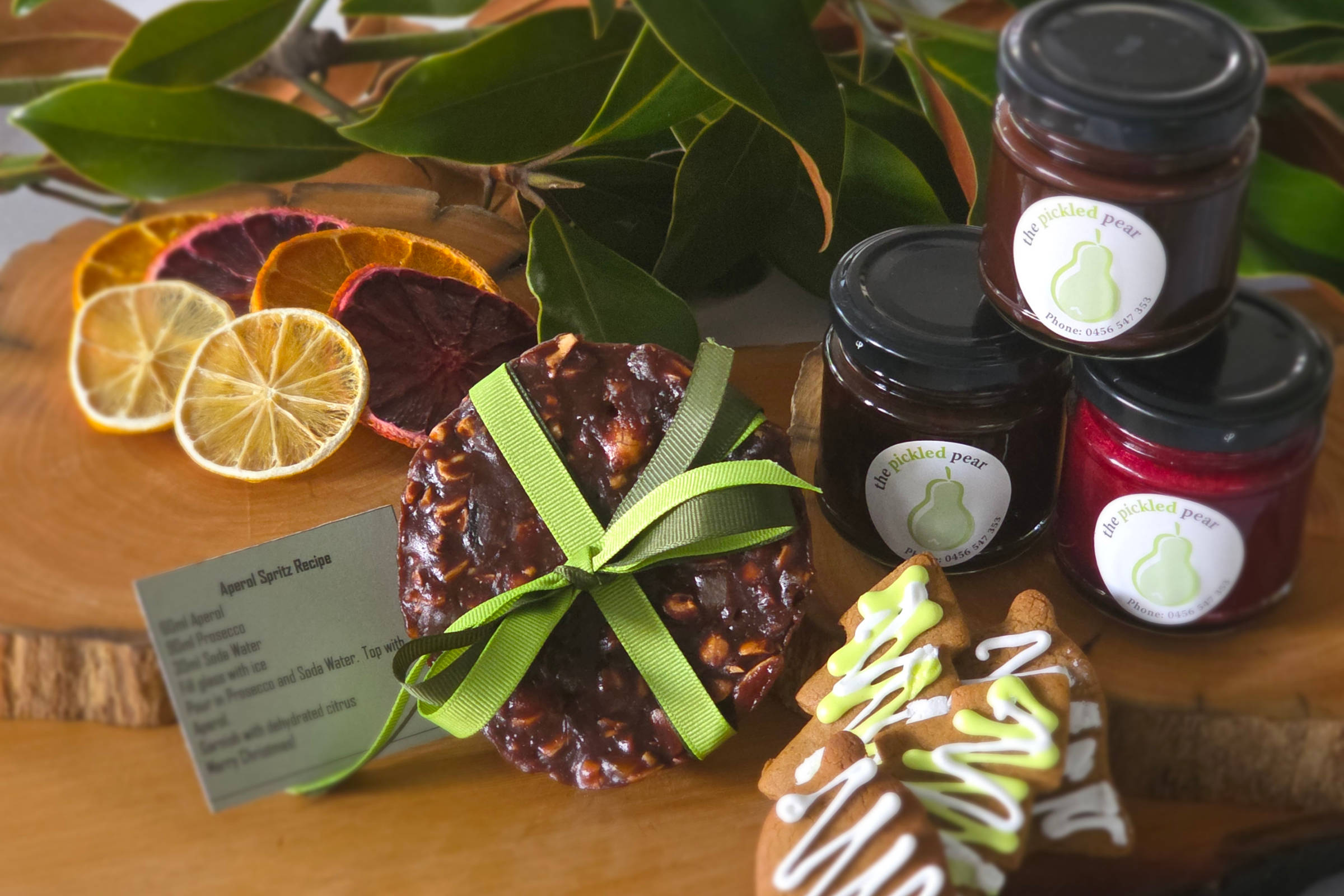 200g chocolate Siena cake, 100mL jar port-soaked raisins, 100mL jar raspberry coulis, 100mL jar chocolate whisky sauce, Aperol spritz recipe and dehydrated citrus, 2 × gingerbread cookies. Credit: Pickled Pear.